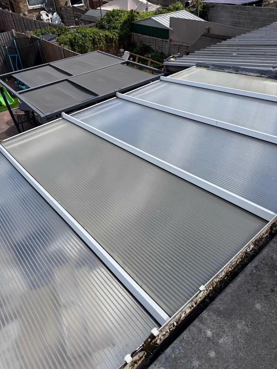 A glass conservatory roof reflecting the sky after cleaning
